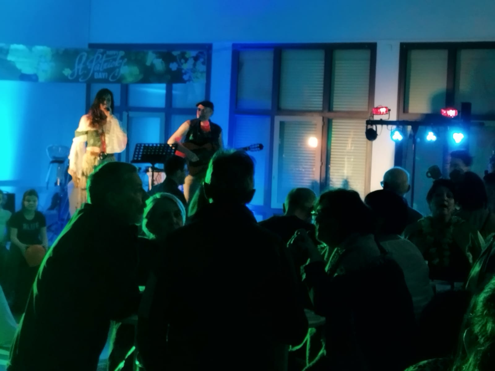 Le duo sur scène face au public dans une salle